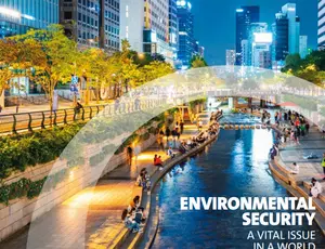 This is the cover of Veolia's Integrated Report 2025-2026 titled "Environmental Security: A Vital Issue in a World Under Pressure." The image shows an urban waterfront at evening with modern buildings, illuminated trees, and a restored canal or stream where people gather on wooden decking, illustrating sustainable urban water management and community engagement.